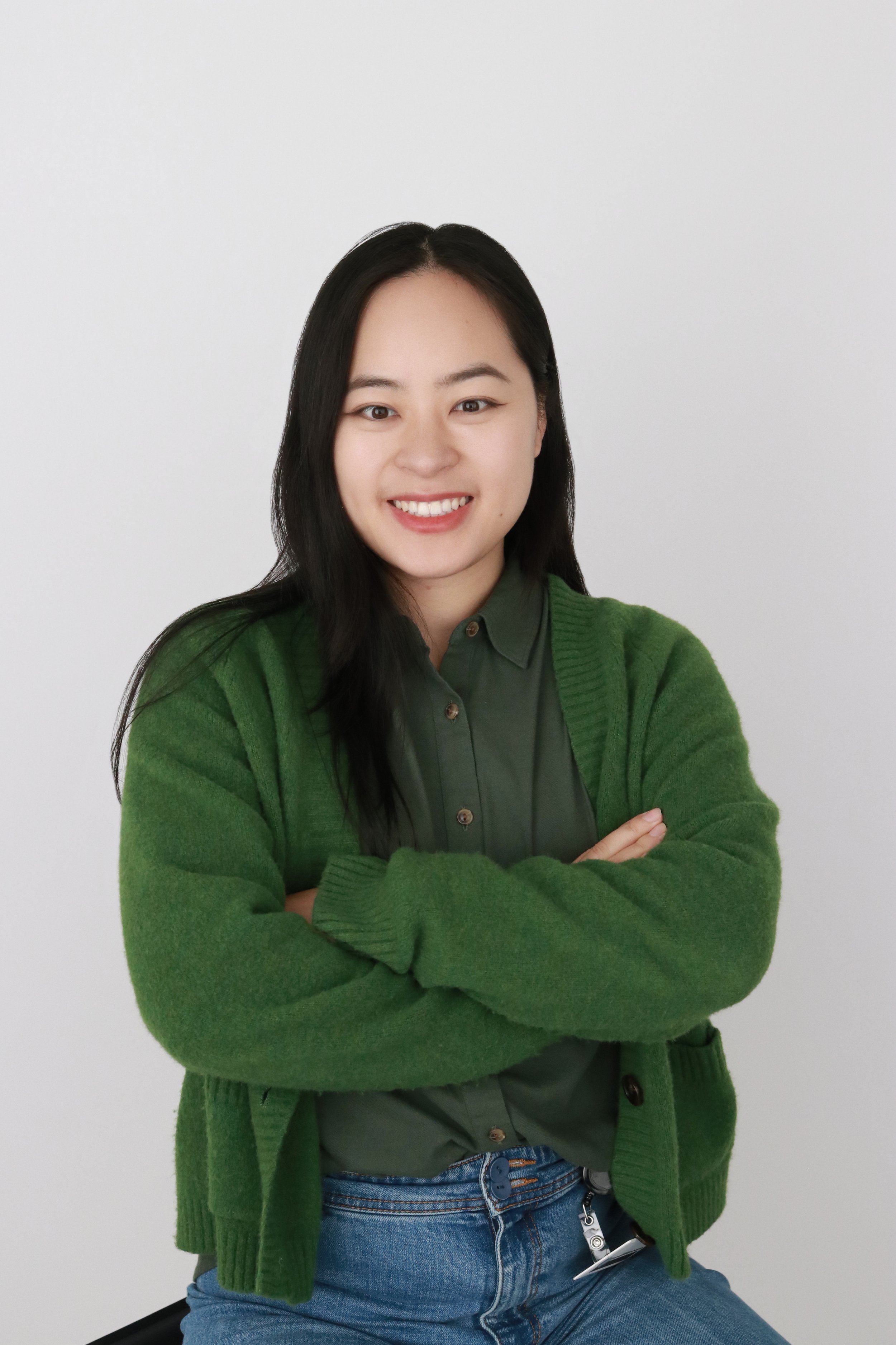 Woman's Headshot in a Green Jacket