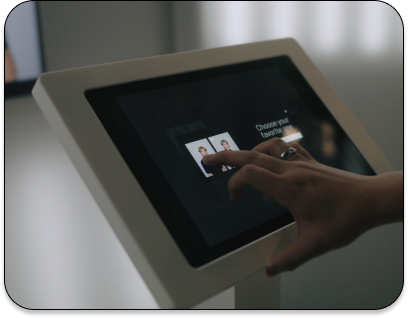 Person using a touchscreen device in a modern indoor setting.